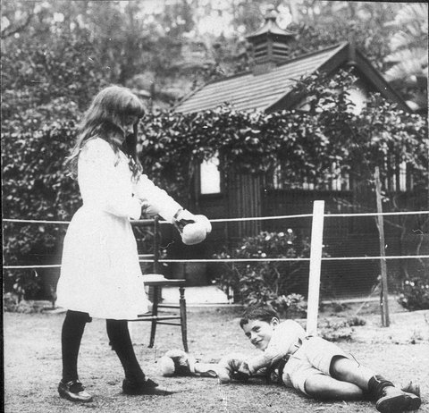 Banjo Paterson's children Grace and Hugh boxing with Christmas present gloves, Sydney, NSW, 1919 - photographer unknown