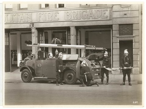 Five firemen, Metropolitan Fire Brigade engine and crew, Castlereagh Street headquarters, (pre-1955) - photograph Sutcliffe Pty Ltd, 1920–80