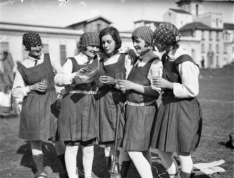Five schoolgirl hockey players enjoy a glass of lemonade, Sydney University, 192- - photographer Sam hood, 1929