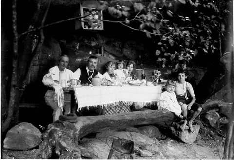 Perier family in kitchen of camp in rock shelter, Middle Harbour, c. 1900 by A.J. Perier
