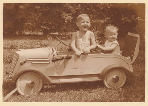 Boy in pedal car with baby in 'rumble seat', Sydney, ca. 1935 - photographer Sam Hood, c. 1935