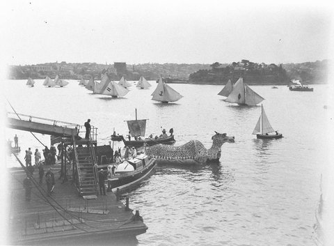 Eighteen footers sail past the 'Sea Dragon', c. 1934, by Sam Hood