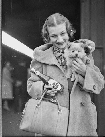 Ballet star Helene Kirsova with puppy and tomato sauce bottle on arrival back in Sydney for a return season, Central Railway Station, May 1937 - Sam Hood