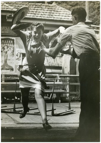 Woman leaping for the ferry caught by deckhand, Sydney Harbour, 1940 - possibly Pix