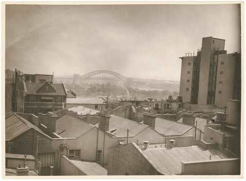Looking across the rooftops from Potts Point to the Harbour Bridge, after March 1932, by Sam Hood