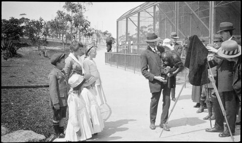 Man has his photograph taken with an orang-outang, Taronga Zoo, c. 1916, by Sam Hood