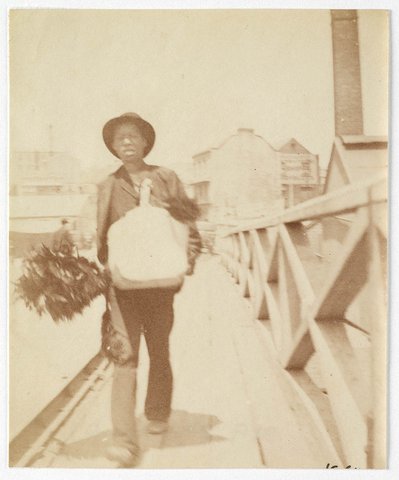 A chimney sweep (?) walking across Pyrmont Bridge Sydney, ca. 1885-1890 - photographed by Arthur K. Syer, 1885–90