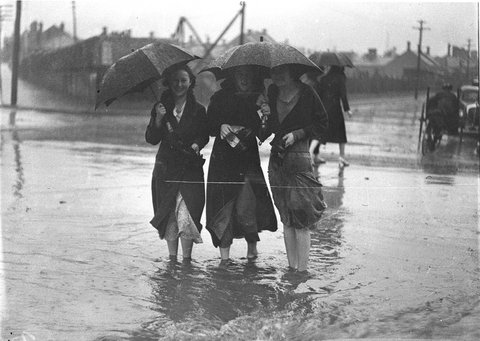 People crossing a flooded street at Alexandria, Sydney, 6 September 1934, by Sam Hood