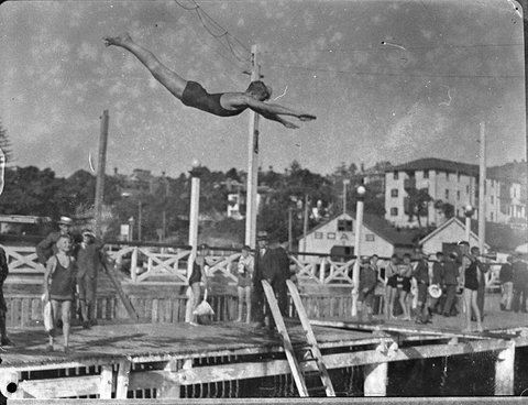 A young diver in the air as he dives from the high-board, St Aloysius College swimming at Manly, 17 March, 1935, by Sam Hood