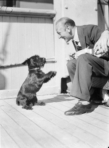 On the ship "Mongolia"- Chuck Arnold and "Jockey" (dog), ca. 1930's - photographer Sam Hood, 1930s