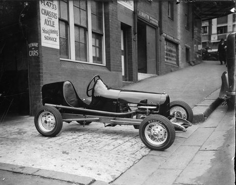 Probably Arch Tuckett's Midget speedcar with Henderson motorcycle engine, having engine work, in lane behind William Street, East Sydney-Woolloomooloo, next to C.A. Martin, decorator, late 1934 - Sam