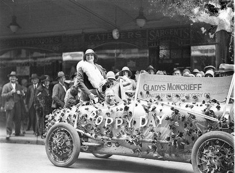 Gladys Moncrieff rides a poppy-laden float, donated by Holeproof Hosiery Company, 11 Nov 1927-1930 - by Sam Hood, 1927–30