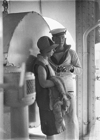 Sailor of HMAS "Australia" fondles woman's string of pearls, c. 1929 - by Sam Hood