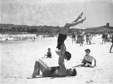 Mr J Prentice and Miss J Howat performing beach acrobatics at Bondi Beach, 2 Jan 1935 - by Ted Hood