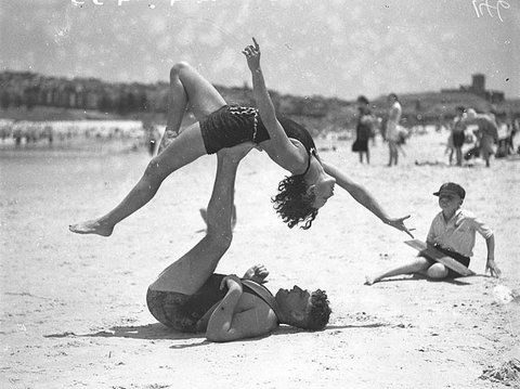 Mr J Prentice and Miss J Howat doing acrobatics, Bondi Beach, Jan 1935 - by Ted Hood