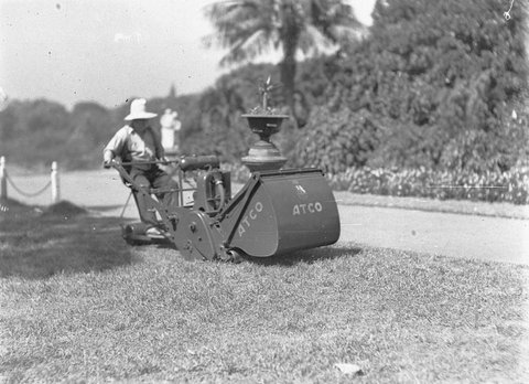 Gardener on Atco ride-on lawn mower, c. 1932, by Ted Hood
