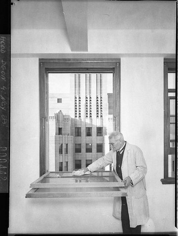 A.P.A. Building. The inventor demonstrates the detail of a new steel frame demountable window for cleaning, Nov. 1937, by Sam Hood