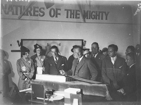 Some VIPs sign the visitors' book before going up to the lookout. Two pylon hostesses in picture, c. 1930s, by Sam Hood