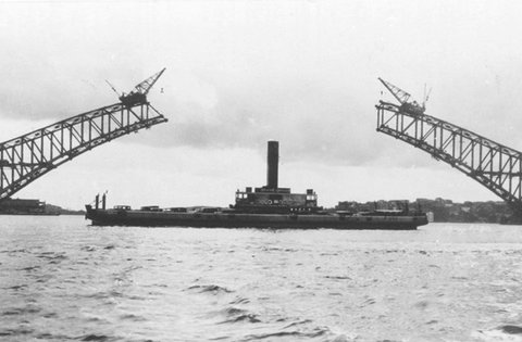 Sydney vehicular ferry KOONDOOLOO in 1929 near Sydney Harbour Bridge under construction