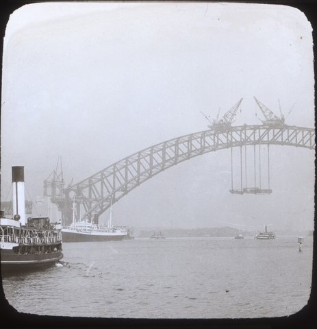 Sydney ferry BELLUBERA and Sydney Harbour Bridge under construction, c. 1930